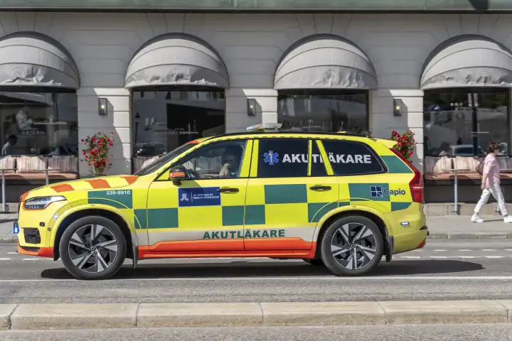 Stockholm, Sweden - 21 July 2023: An emergency medical vehicle with blue lights on the way to a mission in Stockholm, Sweden