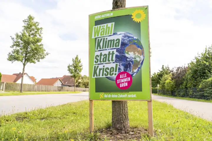 Stettenhofen, Bavaria, Germany - 31 August 2023: An election poster for the state election in Bavaria hangs on the street in a village. The party the Greens advertise with the slogan: Vote climate instead of crisis