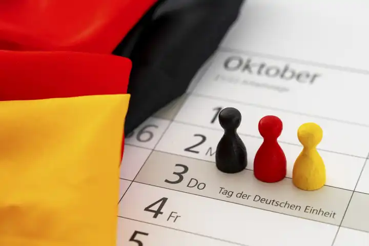Symbolbild Tag der Deutschen Einheit Feiertag und Brückentag in Deutschland. Kalender mit Deutschland Landesflagge
