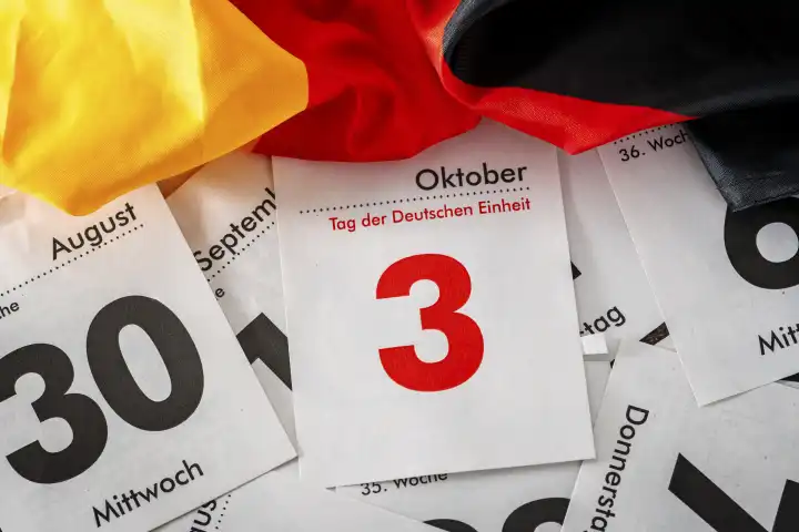 Augsburg, Bavaria, Germany - 30 September 2023: Iconic German Unity Day holiday and bridge day in Germany. Calendar page with 3 October with Germany national flag