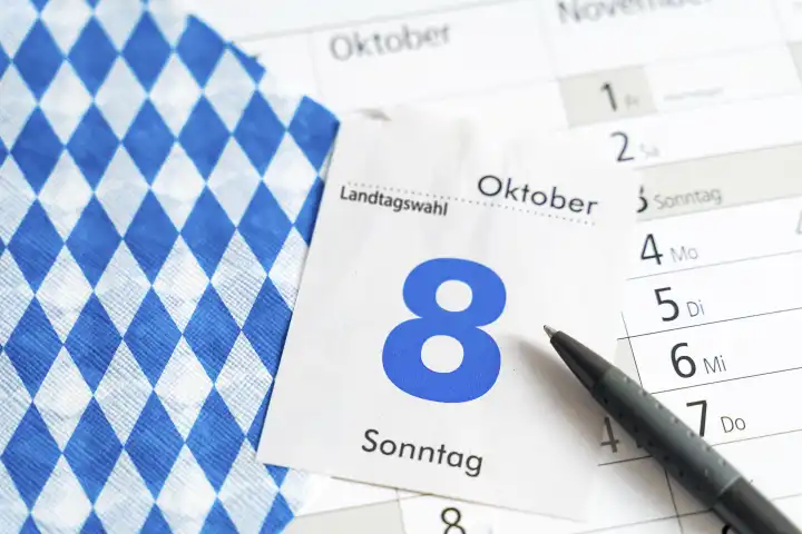 Augsburg, Bavaria, Germany - 7 October 2023: Symbol image for the state election in Bavaria on October 8.  Calendar page with pen on a calendar PHOTOMONTAGE