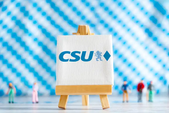 Augsburg, Bavaria, Germany - 7 October 2023: Bavarian state election on 8 October, canvas with party logo CSU Christian Social Union in Bavaria in front of Bavarian flag background PHOTOMONTAGE