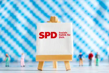 Augsburg, Bavaria, Germany - 7 October 2023: Bavarian state election on 8 October, canvas with party logo SPD Social Democratic Party of Germany in front of Bavarian flag background PHOTOMONTAGE
