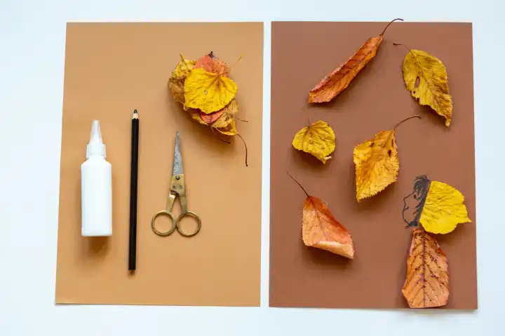 Kreatives Basteln im Herbst, Kunst Material wie Papier, Stifte und Kleber sowie bunte Blätter liegen auf einem Tisch. Kinderbasteln