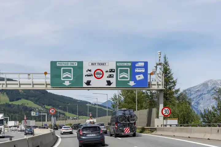 Traffic jam at the toll station in Austria on the Brenner highway with road signs for the digital route toll