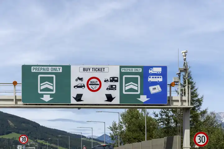 Traffic jam at the toll station in Austria on the Brenner highway with road signs for the digital route toll