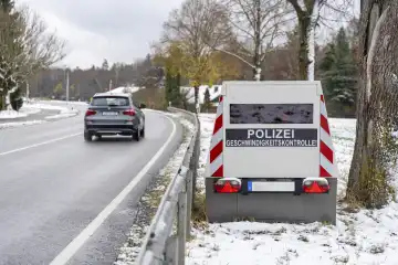Bavaria, Germany - November 26, 2023: A speed camera trailer of the police on a roadside with the inscription "Polizei Geschwindigkeitskontrolle!", speed trap