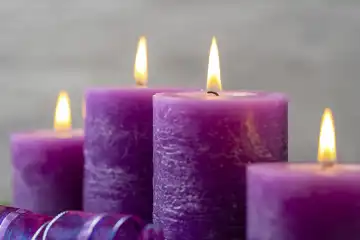 November 24, 2023: Advent wreath in the trend color purple, four candles burn on a modern Advent wreath at Christmas time
