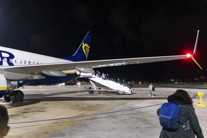 Malta International Airport, Malta - December 4, 2023: Passengers boarding an airplane for boarding the airline Ryanair