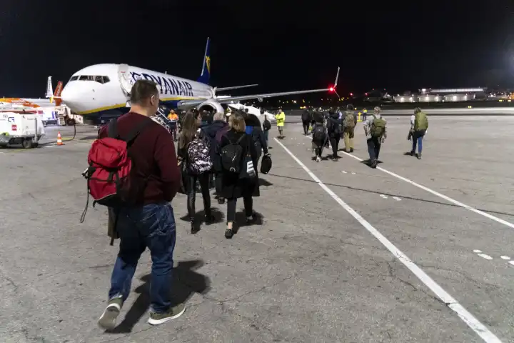 Malta International Airport, Malta - December 4, 2023: Passengers boarding an airplane for boarding the airline Ryanair