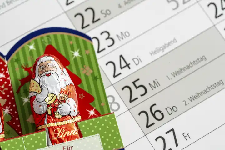 Augsburg, Bavaria, Germany - August 29, 2023: Chocolate Santa Claus on an annual calendar with the date of Christmas December 24, 25 and 26
