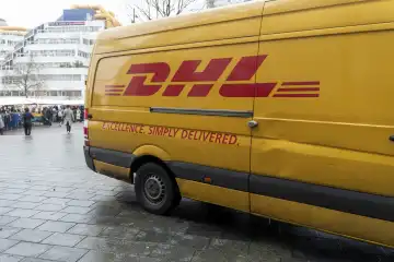 Rotterdam, Netherlands - December 5, 2023: DHL Parcel Service delivery van in a pedestrian zone in Rotterdam