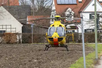 Stettenhofen, Bavaria, Germany - December 28, 2023: Rescue helicopter Christoph 40 of the ADAC Luftrettung lands in a residential area during a mission by the emergency doctor in the village of Langweid OT Stettenhofen