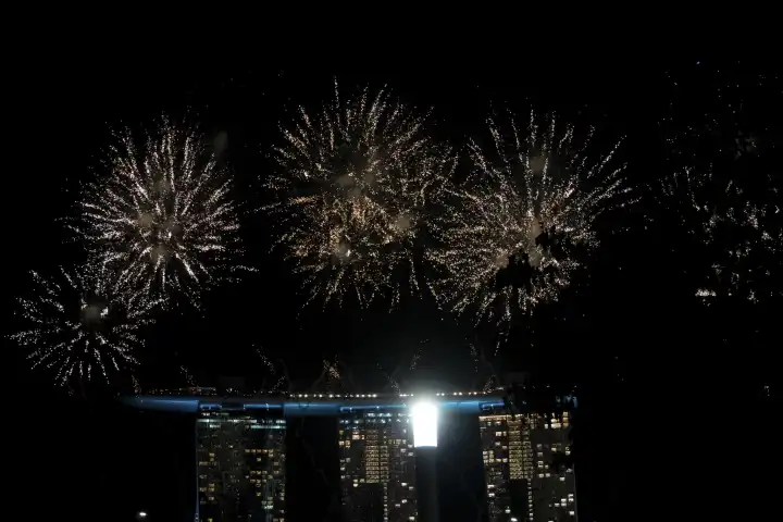 Singapore, Singapore, Asia - December 31, 2023: New Year's Eve and New Year in Singapore Asia people celebrate the New Year 2024 with fireworks in front of the Marina Bay Sands