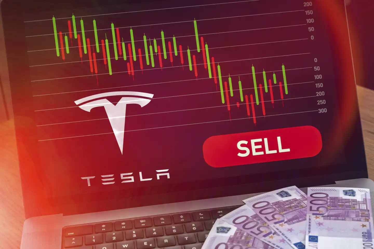 January 25, 2024: Laptop computer with stock chart on red sell signal next to car manufacturer TESLA logo. Symbolic image for the crash and losses of the stock FOTOMONTAGE