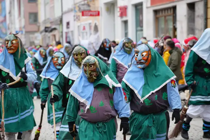 Mindelheim, Bavaria, Germany - February 8, 2024: Big carnival parade on Gumpigen Donnerstag in the city center of Mindelheim. Numerous people are dressed up for carnival