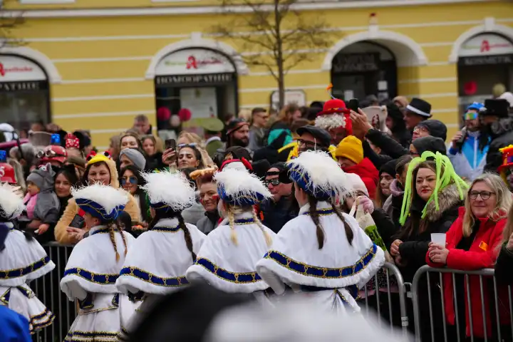 Mindelheim, Bavaria, Germany - February 8, 2024: Big carnival parade on Gumpigen Donnerstag in the city center of Mindelheim. Numerous people are dressed up for carnival