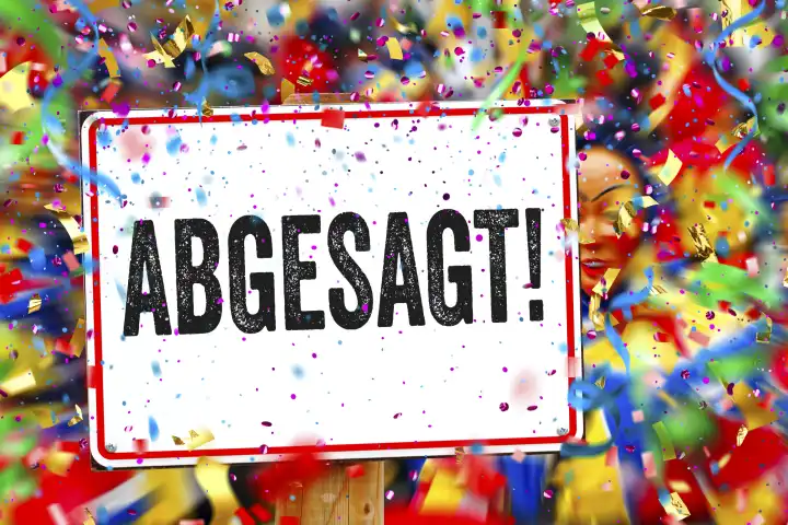 11 February 2024: Canceled! Lettering on a sign in front of a carnival parade with colorful streamers and confetti. PHOTOMONTAGE