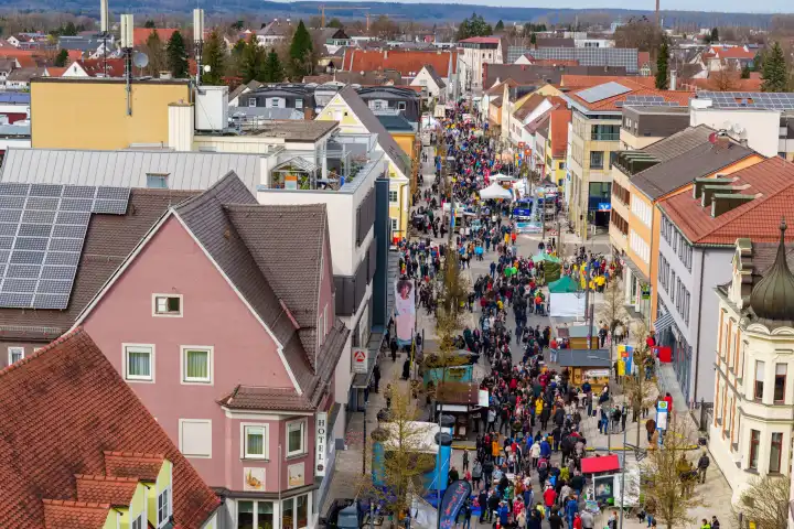 Schwabemünchen, Bavaria, Germany - March 17, 2024: Schwabmünchen spring festival above the rooftops, or rather from the air. Crowd at a festival with a view over the Schwabmünchen region