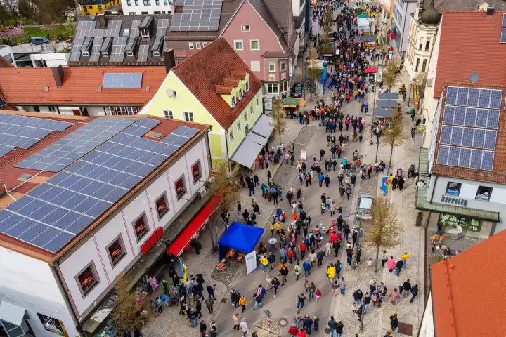 Schwabemünchen, Bavaria, Germany - March 17, 2024: Schwabmünchen spring festival above the rooftops, or rather from the air. Crowd at a festival with a view over the Schwabmünchen region