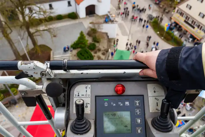 Schwabmünchen, Bavaria, Germany - March 17, 2024: Rescue or operation from the air - fire department turntable ladder in action with control panel and joystick, photographed from the rescue cage of an aerial rescue vehicle at height. Exercise of the Schwabmünchen fire department at the spring festival
