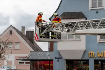 Schwabmünchen, Bavaria, Germany - March 17, 2024: Schwabmünchen Fire Department turntable ladder operation for a person rescue with rescue cage, exercise and demonstration of a realistic operation at the spring festival