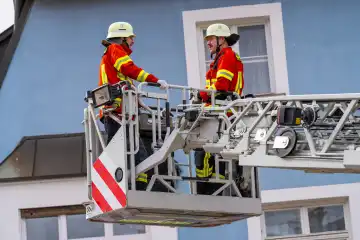Schwabmünchen, Bavaria, Germany - March 17, 2024: Schwabmünchen Fire Department turntable ladder operation for a person rescue with rescue cage, exercise and demonstration of a realistic operation at the spring festival