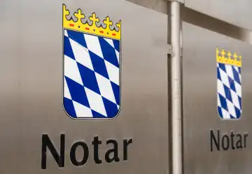 Schwabmünchen, Bavaria, Germany - March 17, 2024: Notary symbol and lettering on a metal sign