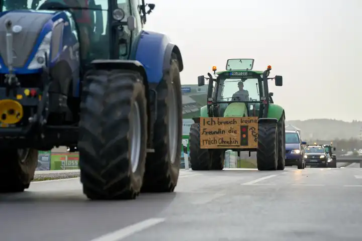 Türkheim / Bad Wörishofen, Bavaria, Germany - March 30, 2024: Easter weekend demonstration of tractors and cars against the traffic light government's policy. Posters on tractors and vehicles on the country road in Unterallgäu between Türkheim and Bad Wörishofen