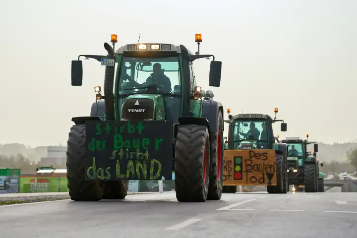 Türkheim / Bad Wörishofen, Bavaria, Germany - March 30, 2024: Easter weekend demonstration of tractors and cars against the traffic light government's policy. Posters on tractors and vehicles on the country road in Unterallgäu between Türkheim and Bad Wörishofen
