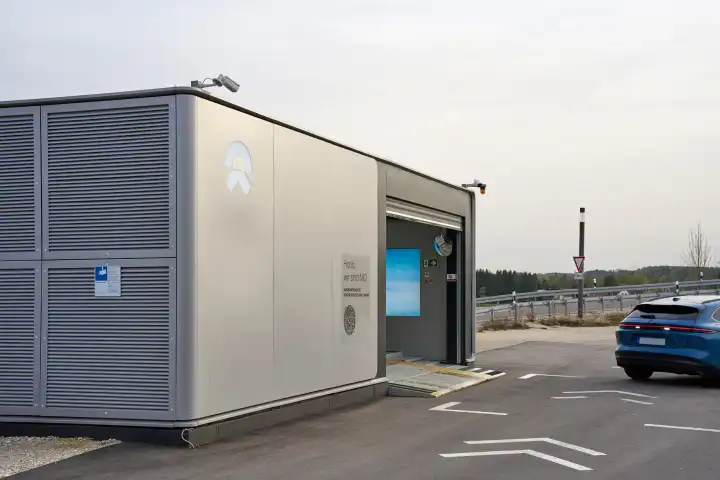 Bavaria, Germany - April 7, 2024: NIO Power Swap Station, charging station for electric cars from Nio. A Nio ET5 drives into the station to swap the battery of the electric car