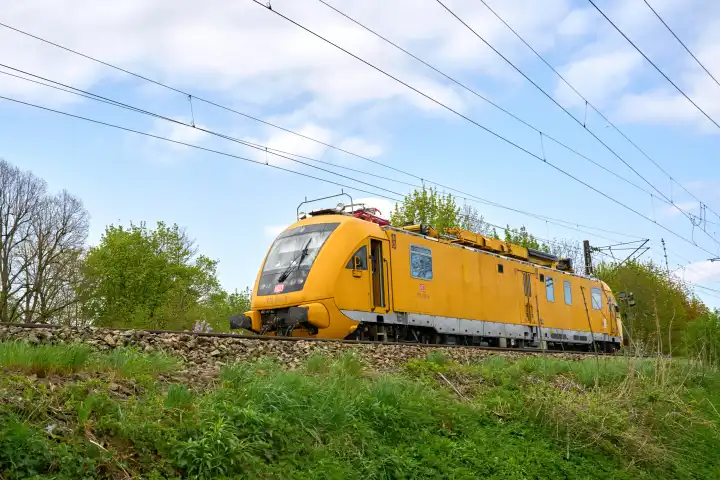 Augsburg, Bavaria, Germany - April 11, 2024: DB Deutsche Bahn maintenance and track measurement train on the move