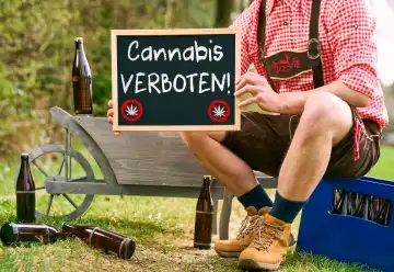 16 April 2024: Themed picture Cannabis and weed banned in beer gardens and public festivals in Bavaria. Man in lederhosen holding a sign with the inscription: Cannabis Verboten! PHOTOMONTAGE