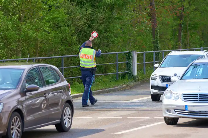 Augsburg, Bavaria, Germany - April 17, 2024: Cross-state safety day for Speedweek or speed camera marathon in Augsburg. Police officer pulls a speeding car out of traffic