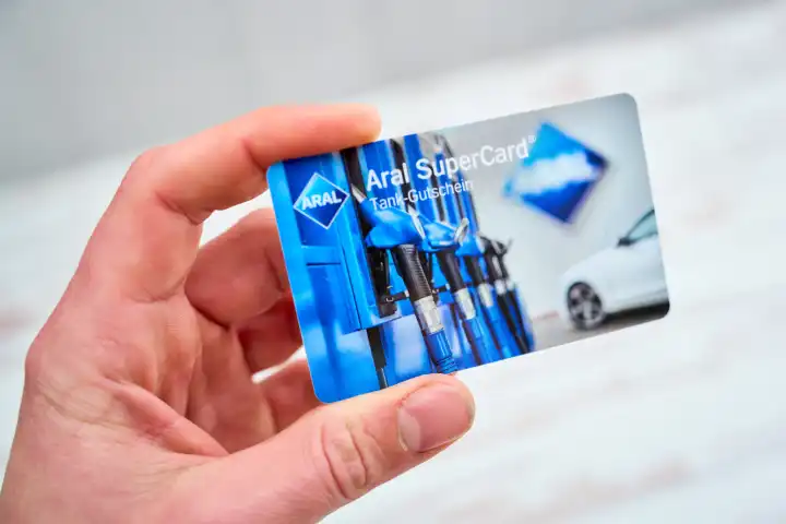 Augsburg, Bavaria, Germany - April 17, 2024: A hand holds a voucher card from the ARAL gas station, the Aral SuperCard
