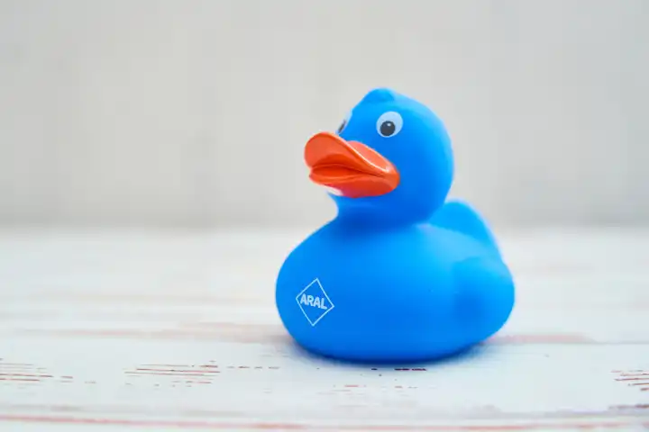 Augsburg, Bavaria, Germany - April 17, 2024: Blue rubber duck with ARAL logo. Promotional gift