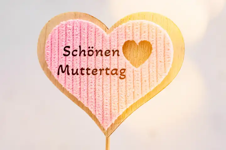 Augsburg, Bavaria, Germany - April 17, 2024: Happy Mother's Day! Greeting on a wooden heart. PHOTOMONTAGE