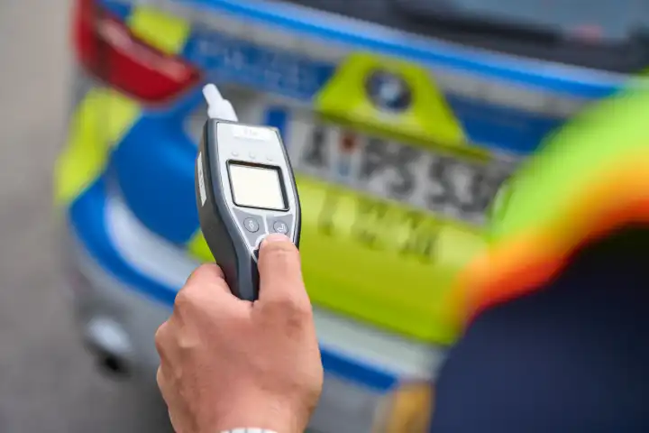 Augsburg, Bavaria, Germany - April 19, 2024: Symbolic photo police check with alcohol test, measuring device for determining the breath alcohol content of road users