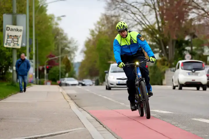 Augsburg, Bavaria, Germany - April 19, 2024: Augsburg police bicycle patrol. Police officer on bicycle