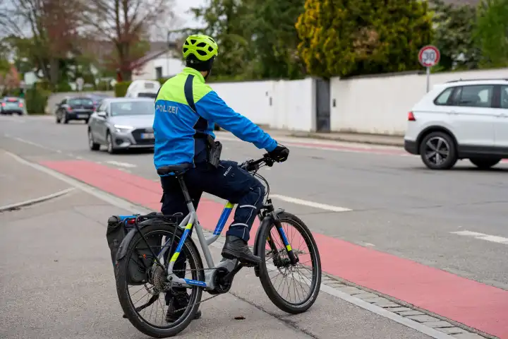 Augsburg, Bavaria, Germany - April 19, 2024: Augsburg police bicycle patrol. Police officer on bicycle