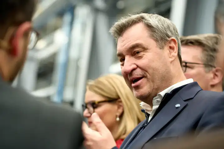 Augsburg, Bavaria, Germany - 24 April 2024: Prime Minister of Bavaria Dr. Markus Söder visits the presentation of the AI Network Augsburg. AI research hall ("Hall 43") of the University of Augsburg. Portrait smiling