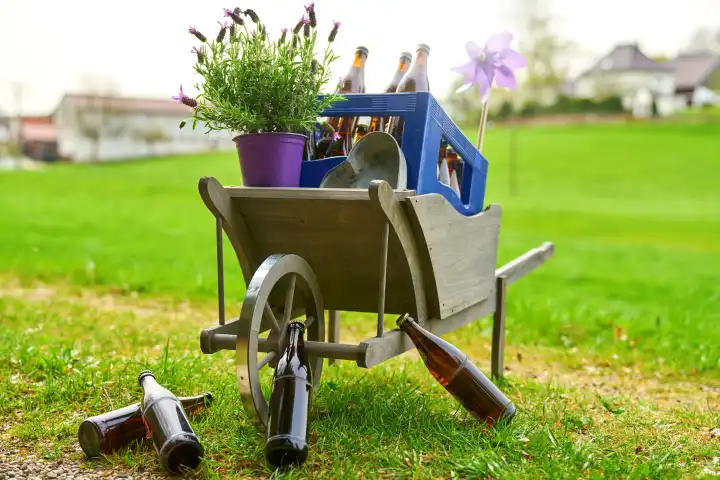  7 April 2024: Handcart wheelbarrow with beer and beer bottles on a green meadow for Father's Day