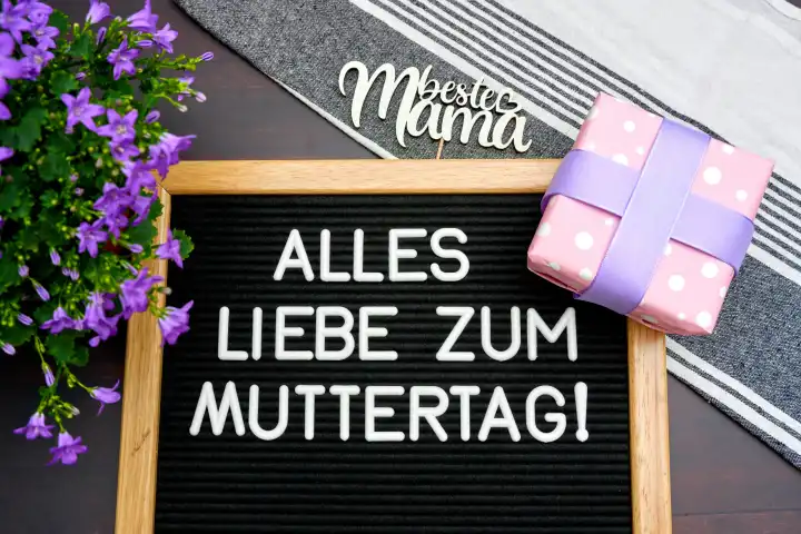 Augsburg, Bavaria, Germany - April 25, 2024: All the best for Mother's Day! Greeting for Mother's Day, on a sign next to flowers and gifts