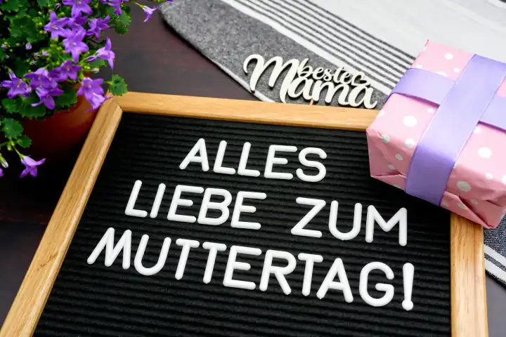 Augsburg, Bavaria, Germany - April 25, 2024: All the best for Mother's Day! Greeting for Mother's Day, on a sign next to flowers and gifts