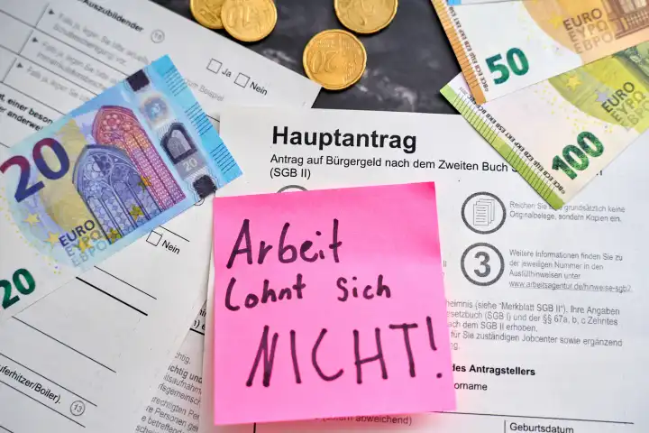 Augsburg, Bavaria, Germany - April 25, 2024: Work is NOT worth it! Note on a citizen's allowance application from the employment agency