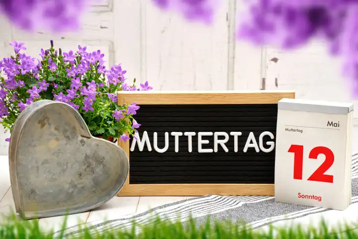 April 25, 2024: Mother's Day, A plaque with the inscription Mother's Day and a calendar with the date May 12 decorated with purple flowers. PHOTOMONTAGE