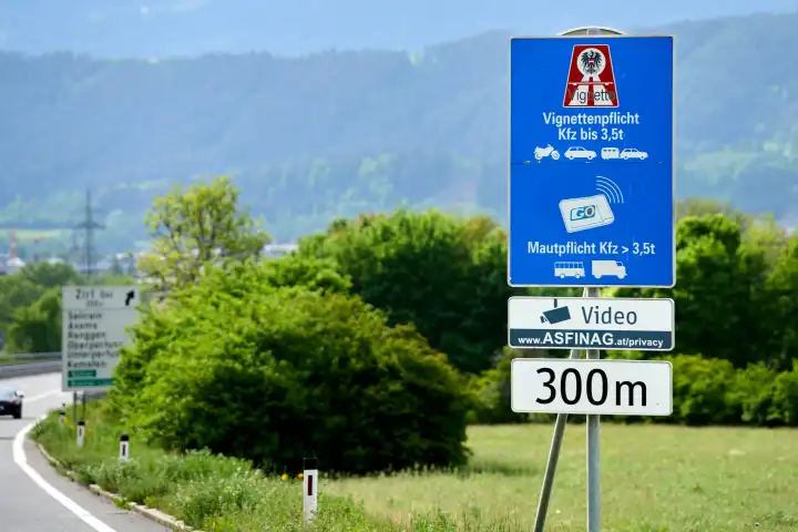 Austria - May 1, 2024: Symbolic image of mandatory vignette on Austrian freeways. Sign on a road in Austria in front of the highway indicating the vignette requirement