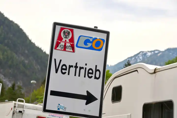 Austria - May 1, 2024: Symbolic image of mandatory vignette on Austrian freeways. Sign with signpost for the sale of vignettes