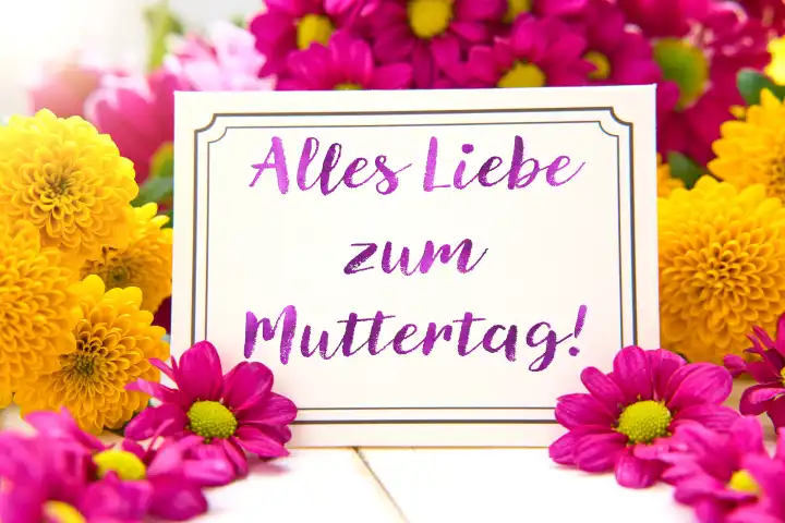 7 May 2024: All the best for Mother's Day! Greeting on a greeting card in front of a colorful bouquet of flowers. PHOTOMONTAGE