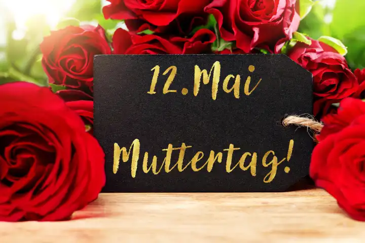 7 May 2024: Red roses with a greeting card and the inscription: May 12 Mother's Day. PHOTOMONTAGE
